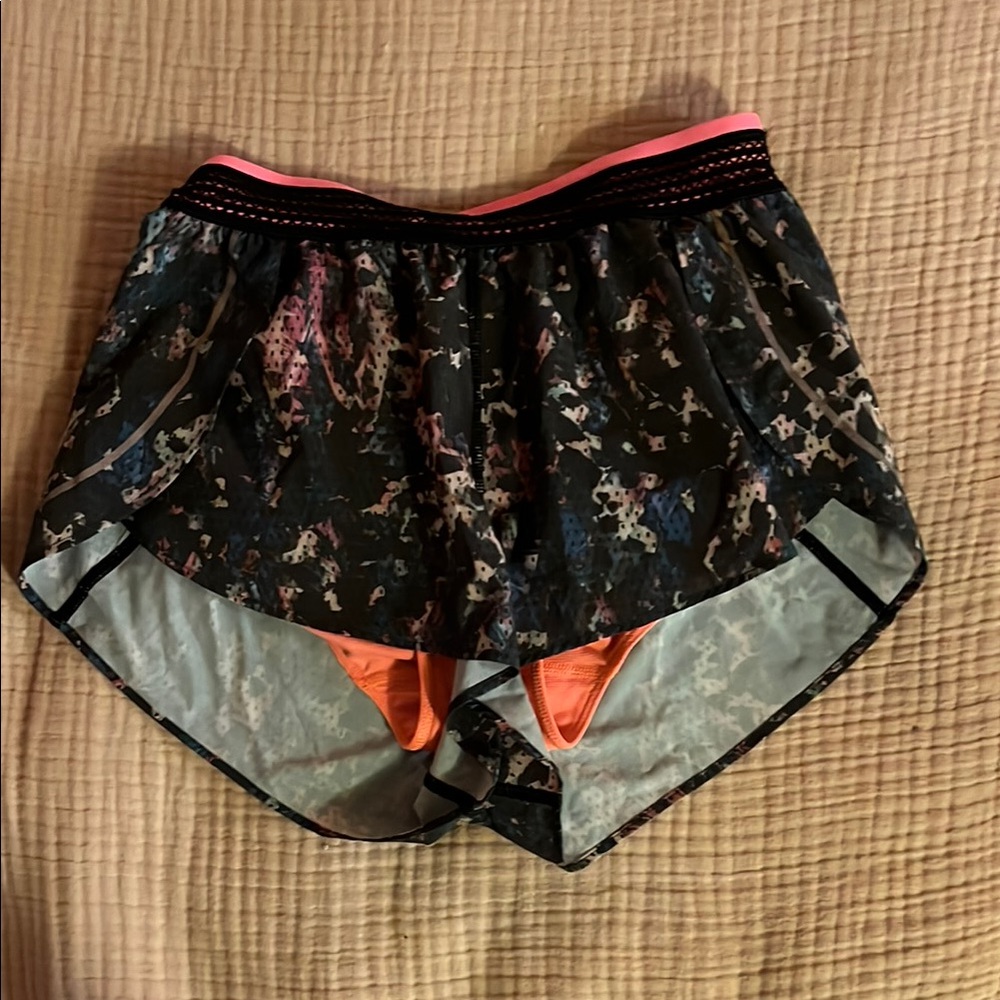 lululemon athletica black athletic shorts with floral print and bright waistband